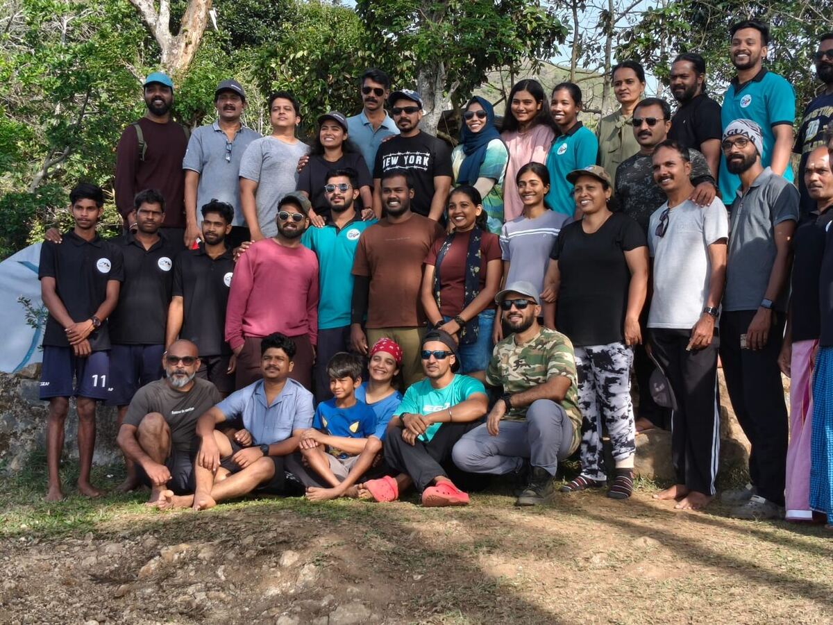 A large group of happy campers gathered at Old Kodai Camping after the trek
